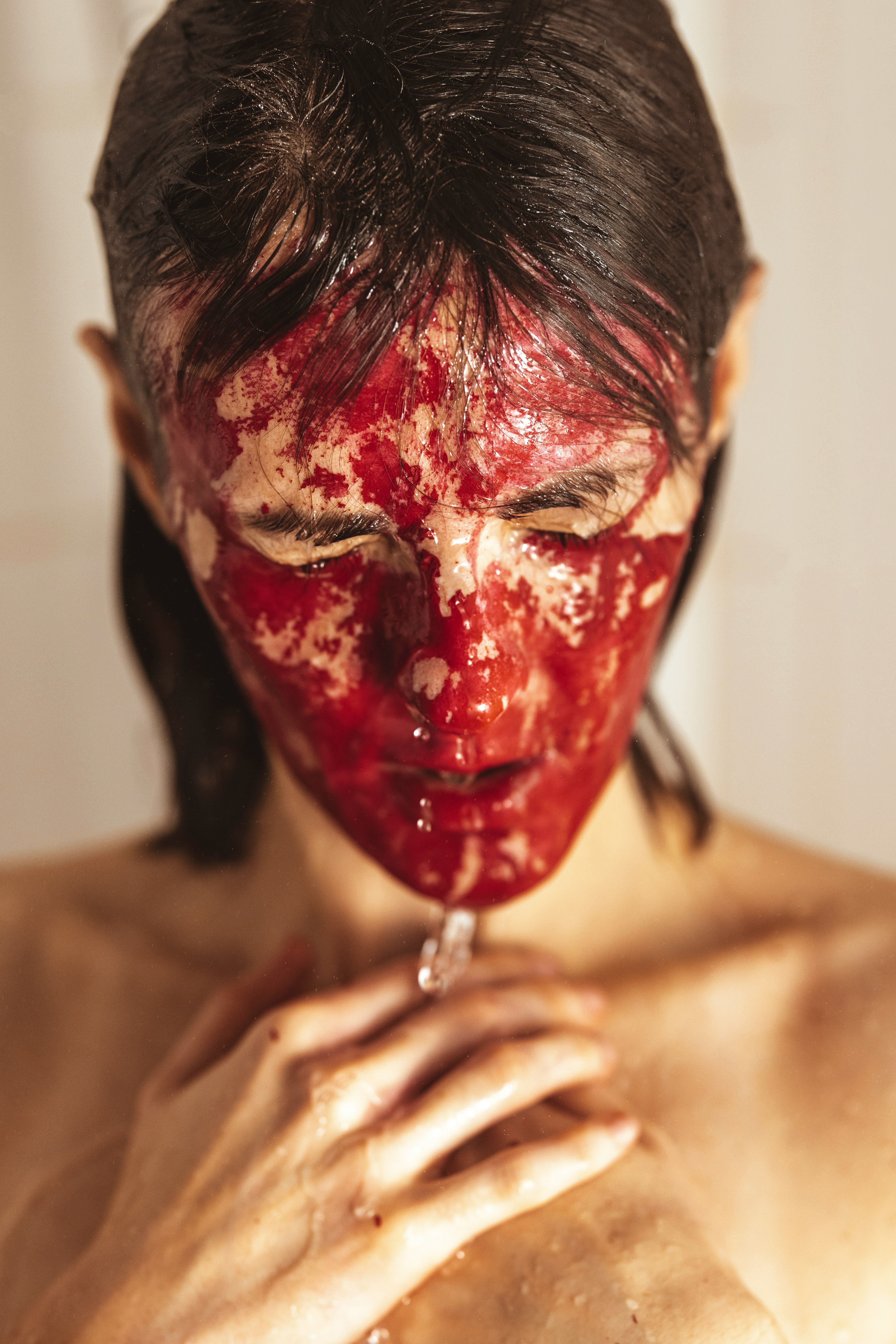 topless man with red paint on face